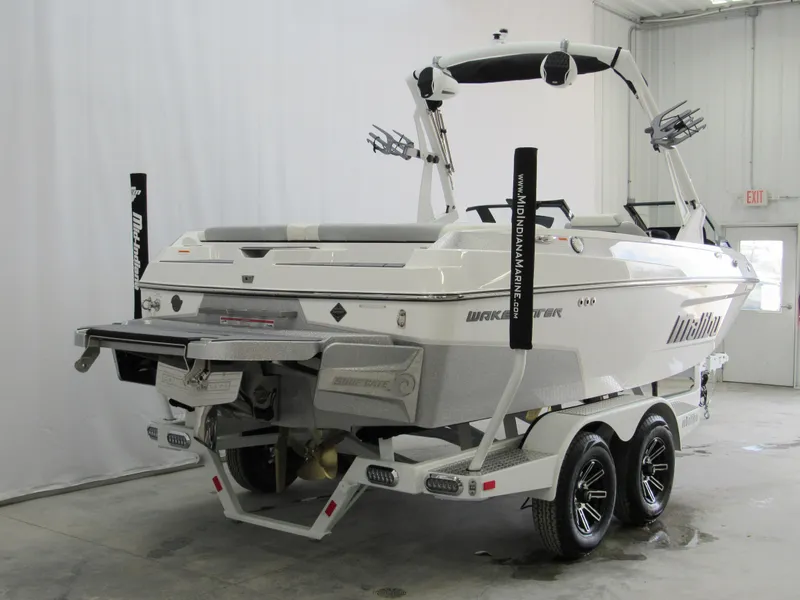 Slide: The Image of 2025 Malibu Wakesetter 20 VTX boat on trailer in indoor storage. - 2