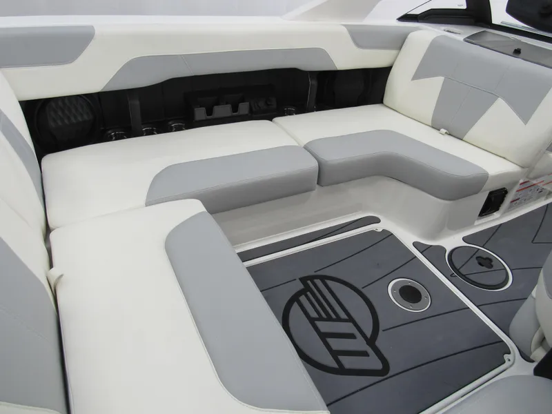 Slide: The Image of 2025 Malibu Wakesetter 20 VTX interior with gray and white seating and logo flooring. - 5