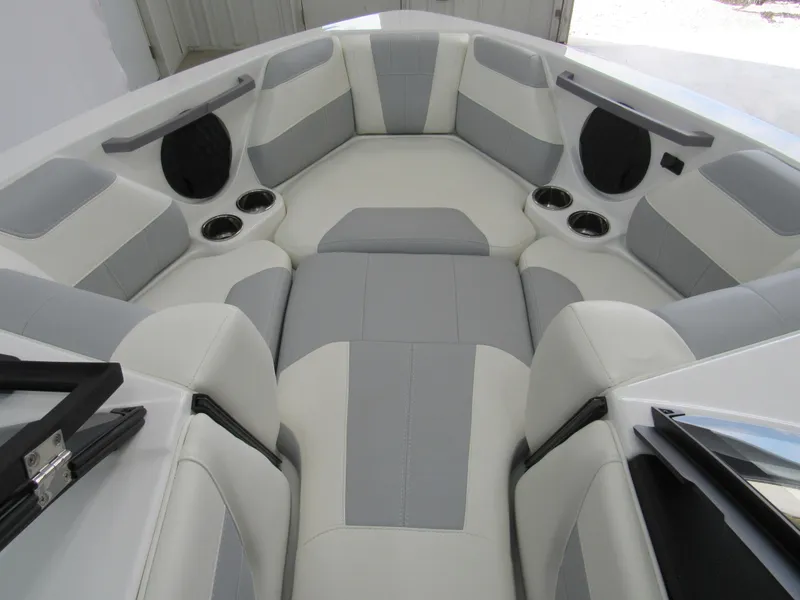Slide: The Image of 2025 Malibu Wakesetter 20 VTX interior with gray and white seating, cup holders, and speakers. - 9