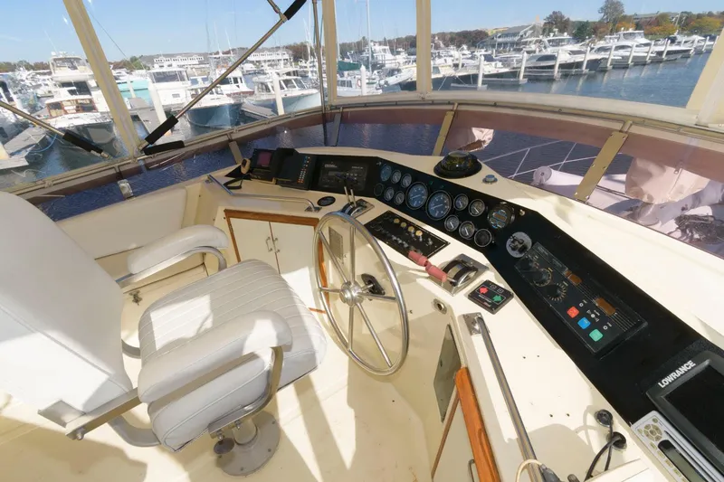 Slide: The Image of Cockpit view of a 1988 Symbol 55 Motor Yacht with marina in the background. - 10