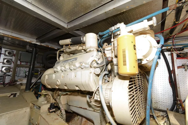 Slide: The Image of Engine room of 1988 Symbol 55 Cockpit Motor Yacht, showcasing mechanical components and systems. - 26