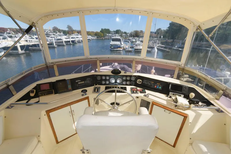 Slide: The Image of Cockpit view of 1988 Symbol 55 Motor Yacht with marina in background. - 8