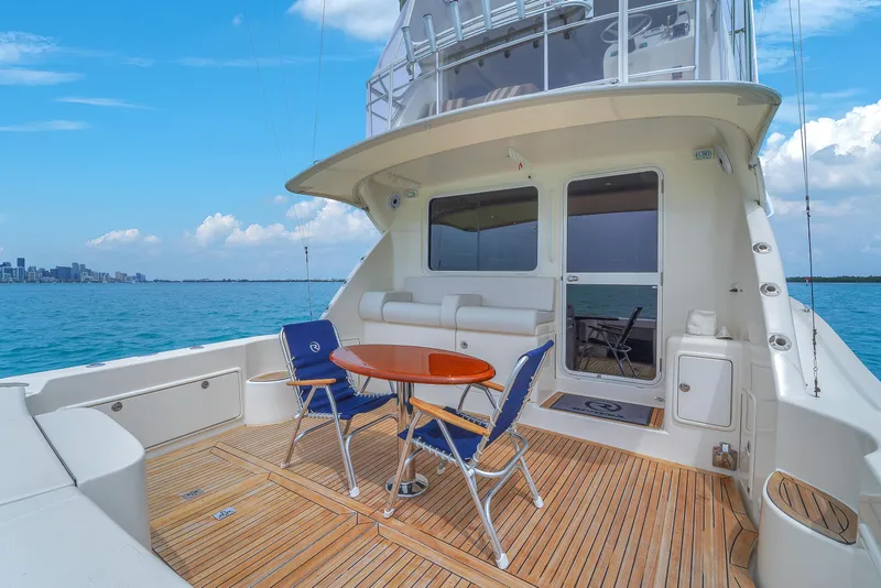 Slide: The Image of 2008 Riviera 51 Enclosed Bridge yacht with teak deck and seating area on open water. - 11