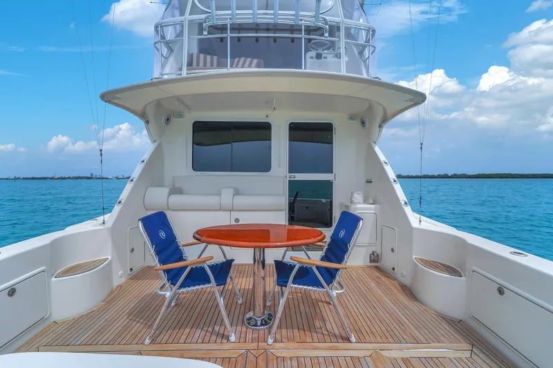 Slide: The Image of 2008 Riviera 51 Enclosed Bridge yacht deck with chairs and table, ocean view. - 12
