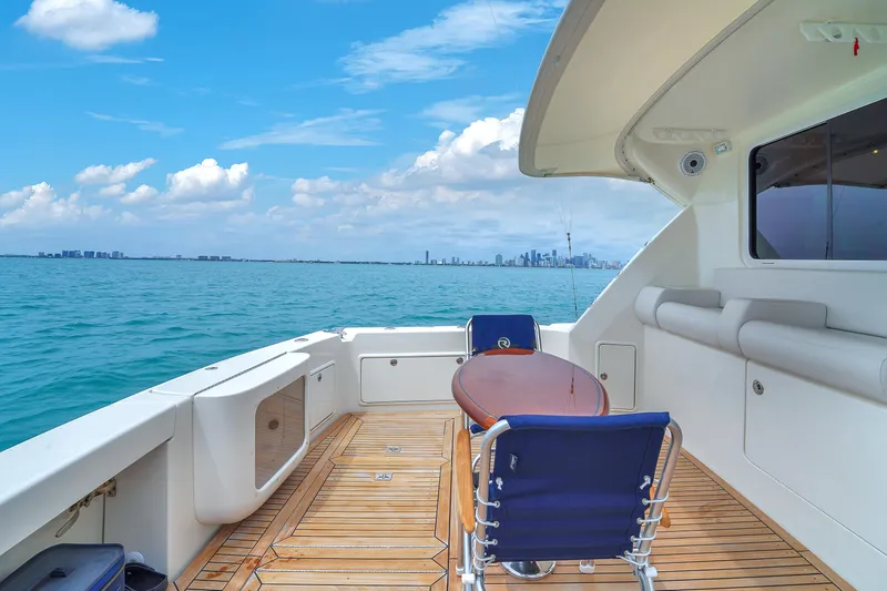 Slide: The Image of 2008 Riviera 51 Enclosed Bridge yacht deck with ocean view and city skyline. - 15