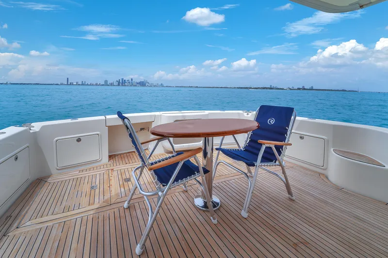 Slide: The Image of Riviera 51 Enclosed Bridge 2008 yacht deck with chairs and table, ocean view. - 16