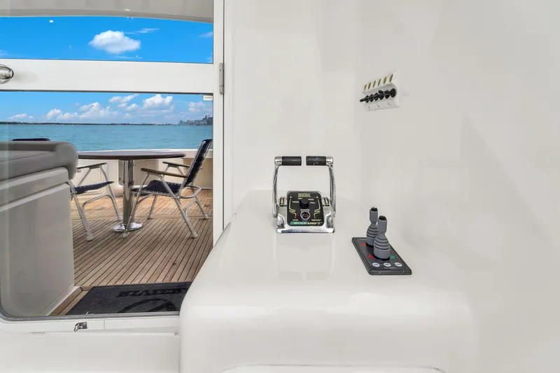 Slide: The Image of 2008 Riviera 51 Enclosed Bridge yacht interior with ocean view and control panel. - 19