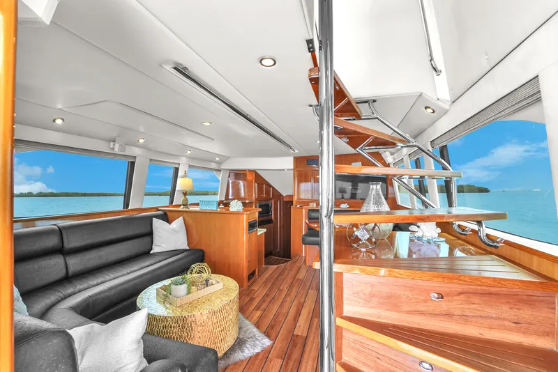 Slide: The Image of Luxurious interior of 2008 Riviera 51 Enclosed Bridge yacht with elegant wood finishes. - 21
