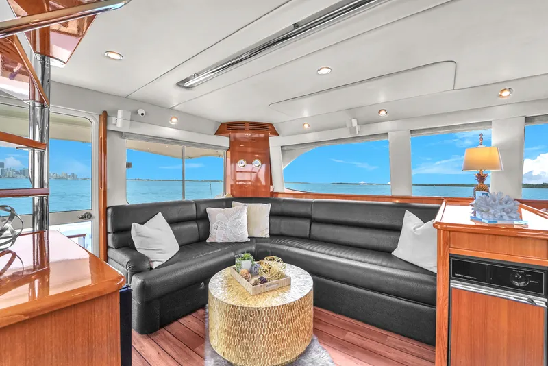 Slide: The Image of Luxurious interior of 2008 Riviera 51 Enclosed Bridge yacht with black leather seating and ocean view. - 22