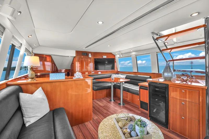 Slide: The Image of Luxurious interior of 2008 Riviera 51 Enclosed Bridge yacht with elegant wood finishes and ocean views. - 25