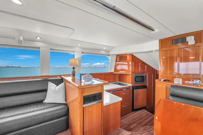 Slide: The Image of Luxurious interior of 2008 Riviera 51 Enclosed Bridge yacht with modern kitchen and seating. - 30