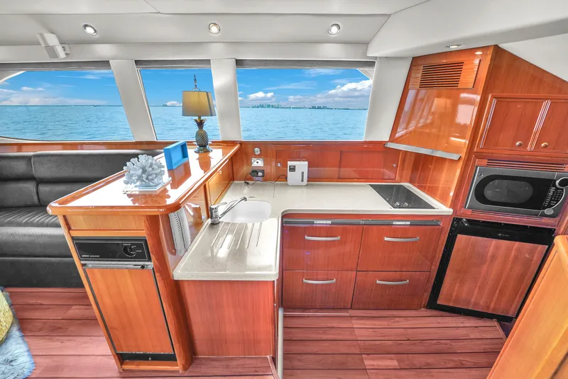 Slide: The Image of Luxurious 2008 Riviera 51 Enclosed Bridge yacht interior with modern kitchen and ocean view. - 31
