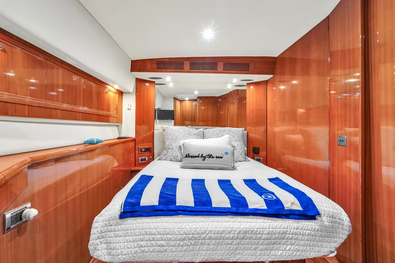 Slide: The Image of Luxurious cabin interior of 2008 Riviera 51 Enclosed Bridge yacht with cozy bedding. - 37