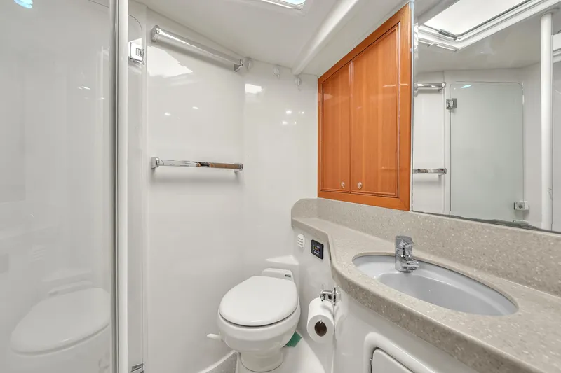 Slide: The Image of Luxurious bathroom in 2008 Riviera 51 Enclosed Bridge yacht, featuring modern fixtures and wood cabinetry. - 39