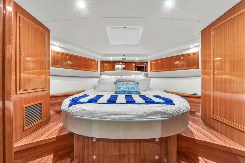 Slide: The Image of Luxurious bedroom interior of 2008 Riviera 51 Enclosed Bridge yacht with wood paneling. - 40