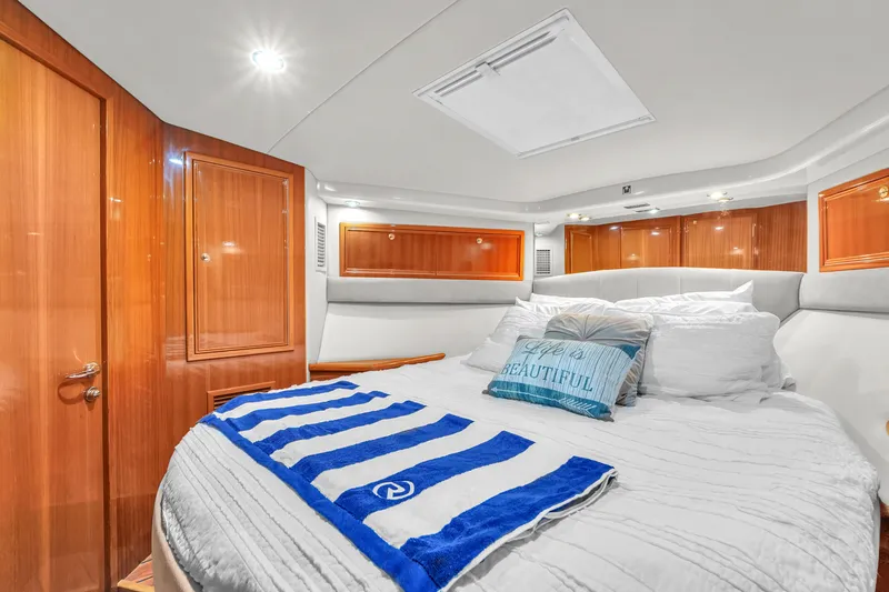 Slide: The Image of Luxurious bedroom interior of 2008 Riviera 51 Enclosed Bridge yacht with elegant wood finishes. - 41