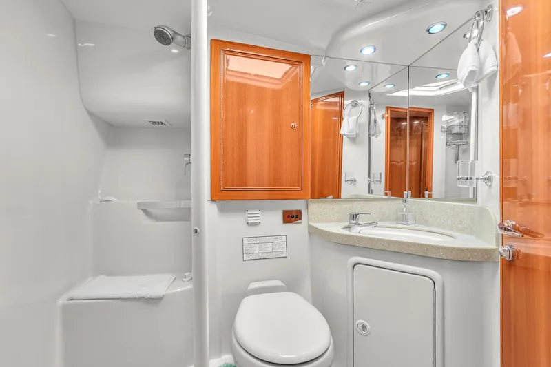 Slide: The Image of Luxurious bathroom in 2008 Riviera 51 Enclosed Bridge yacht with modern fixtures and wooden cabinetry. - 42
