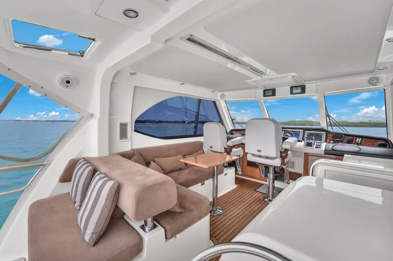 Slide: The Image of Interior of 2008 Riviera 51 Enclosed Bridge yacht with plush seating and ocean view. - 46