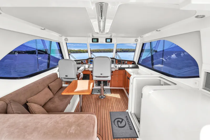 Slide: The Image of Interior of 2008 Riviera 51 Enclosed Bridge yacht with seating and helm. - 47