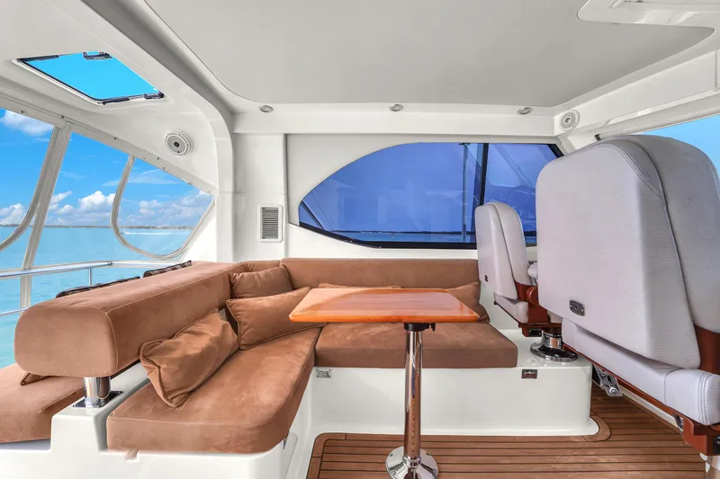 Slide: The Image of Luxurious interior of 2008 Riviera 51 Enclosed Bridge yacht with plush seating and ocean view. - 49