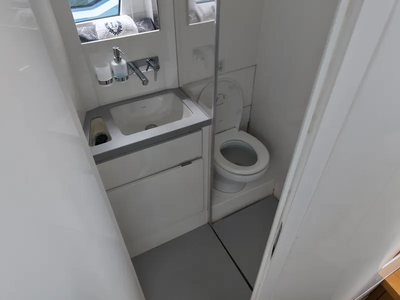 Slide: The Image of Compact bathroom in 2023 Limitless Seas 45 XLV yacht with sink and toilet. - 10