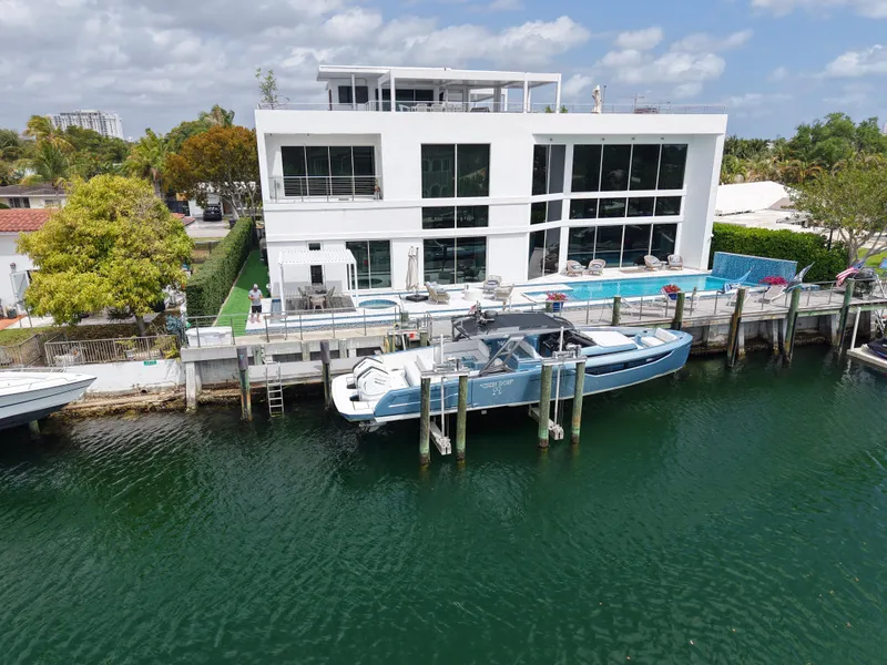 Slide: The Image of Modern waterfront home with Limitless Seas 45 XLV yacht docked, 2023 model. - 3