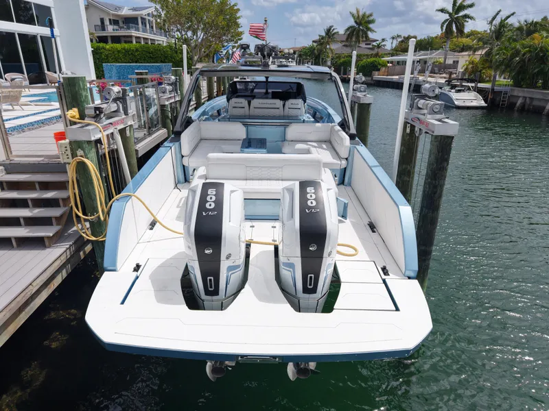 Slide: The Image of 2023 Limitless Seas 45 XLV boat docked with dual outboard engines in a marina. - 6
