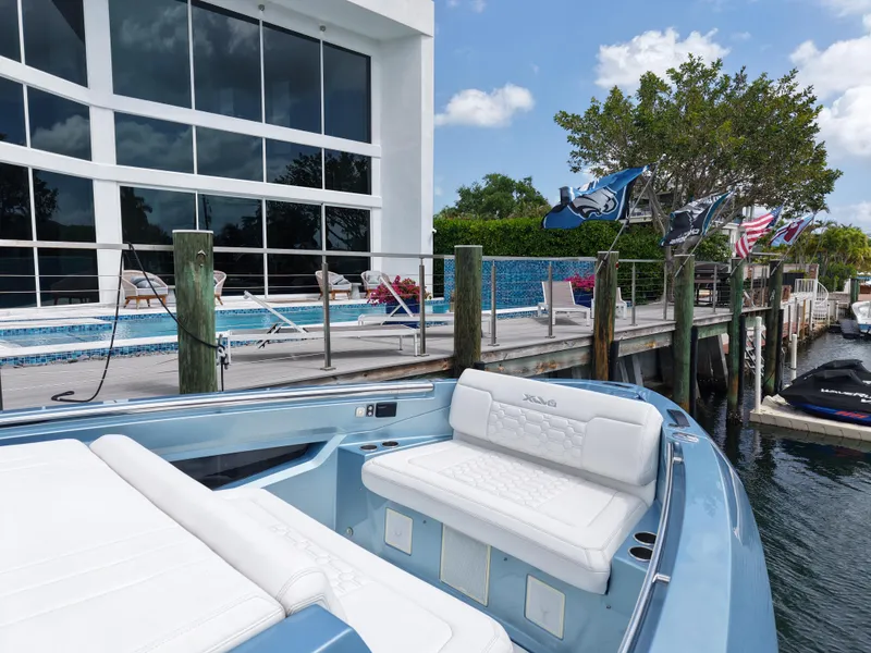 Slide: The Image of Luxurious Limitless Seas 45 XLV yacht docked by a modern waterfront property, 2023 model. - 9