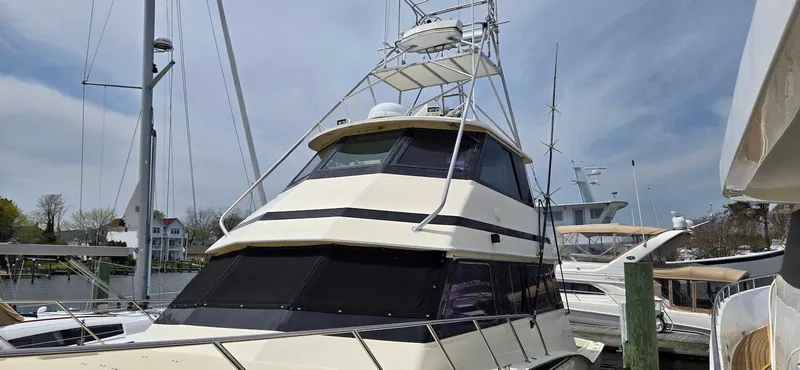 Slide: The Image of 1979 Hatteras 60 Enclosed Bridge Convertible yacht docked at marina. - 10