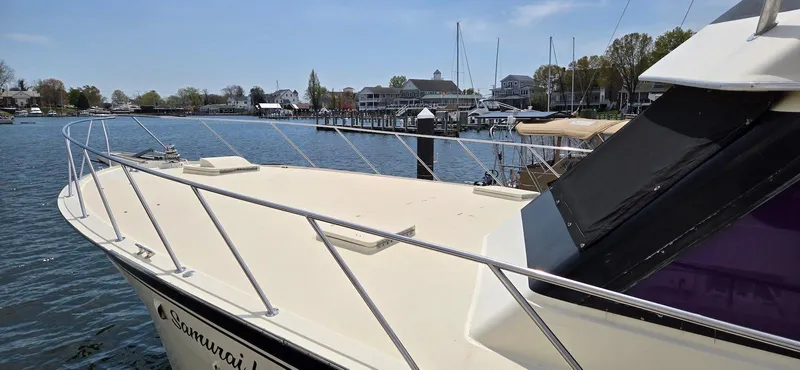 Slide: The Image of 1979 Hatteras 60 Enclosed Bridge Convertible yacht docked in a scenic marina. - 11