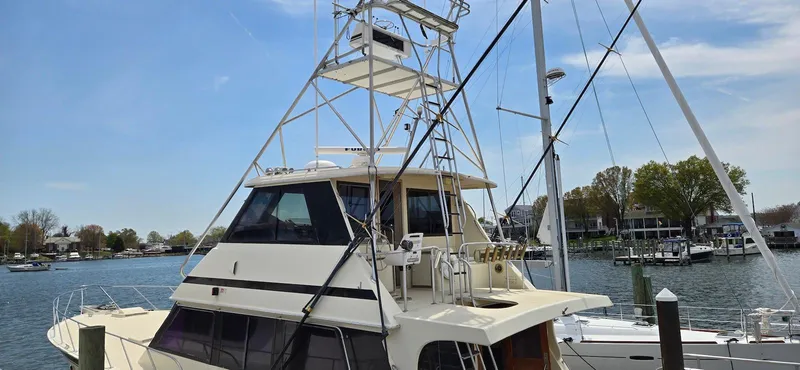 Slide: The Image of 1979 Hatteras 60 Enclosed Bridge Convertible yacht docked at a marina. - 12