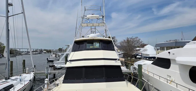 Slide: The Image of 1979 Hatteras 60 Enclosed Bridge Convertible yacht docked at a marina. - 16