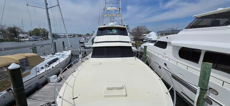 Slide: The Image of 1979 Hatteras 60 Enclosed Bridge Convertible yacht docked at marina. - 17