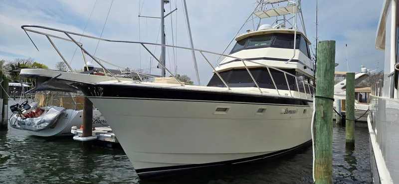 Slide: The Image of 1979 Hatteras 60 Enclosed Bridge Convertible yacht docked at marina. - 2