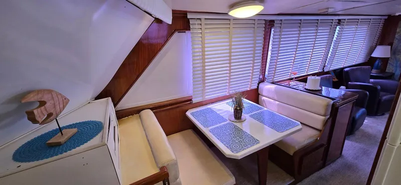 Slide: The Image of Interior of 1979 Hatteras 60 Enclosed Bridge Convertible with dining area and seating. - 26