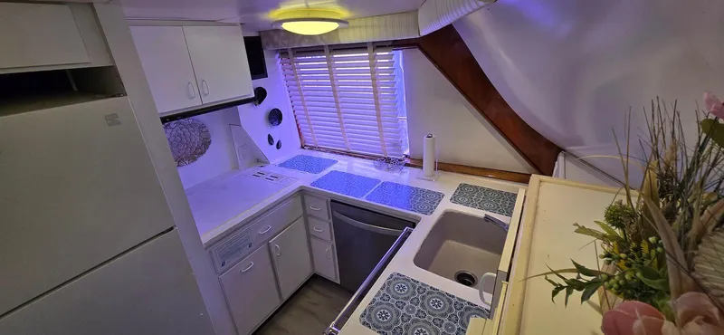 Slide: The Image of 1979 Hatteras 60 Enclosed Bridge Convertible kitchen with modern appliances and stylish decor. - 28