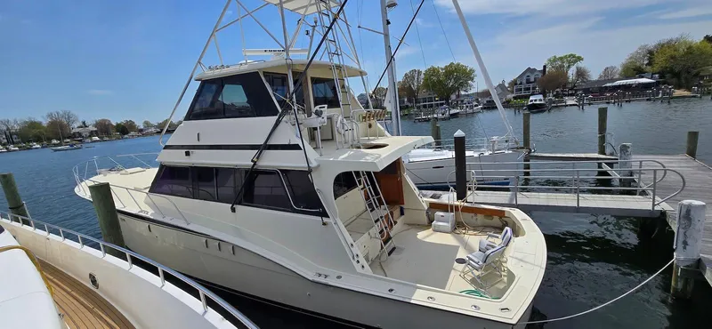 Slide: The Image of 1979 Hatteras 60 Enclosed Bridge Convertible yacht docked at marina. - 6