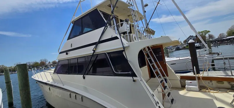 Slide: The Image of 1979 Hatteras 60 Enclosed Bridge Convertible yacht docked at marina. - 7