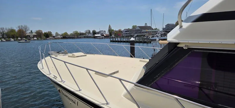 Slide: The Image of 1979 Hatteras 60 Enclosed Bridge Convertible yacht docked in a serene marina. - 8