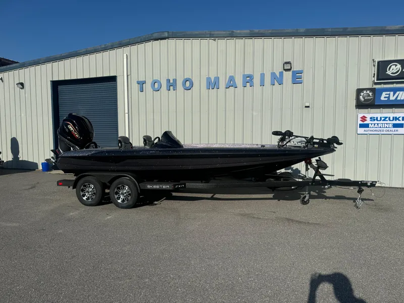 Slide: The Image of 2025 Skeeter ZXR20SE boat at Toho Marine dealership, parked on a trailer. - 0