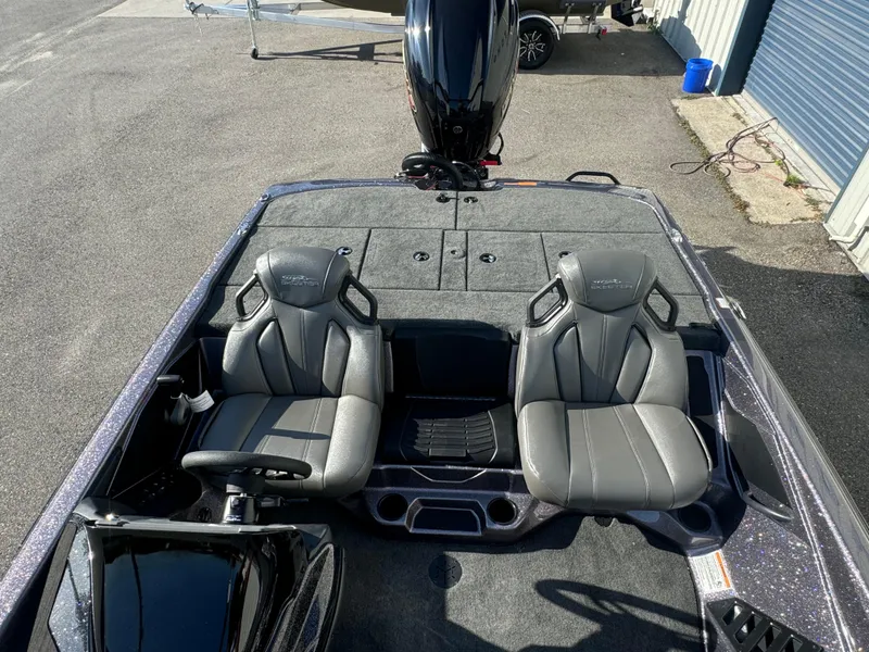 Slide: The Image of 2025 Skeeter ZXR20SE boat interior with two gray seats and steering wheel. - 11