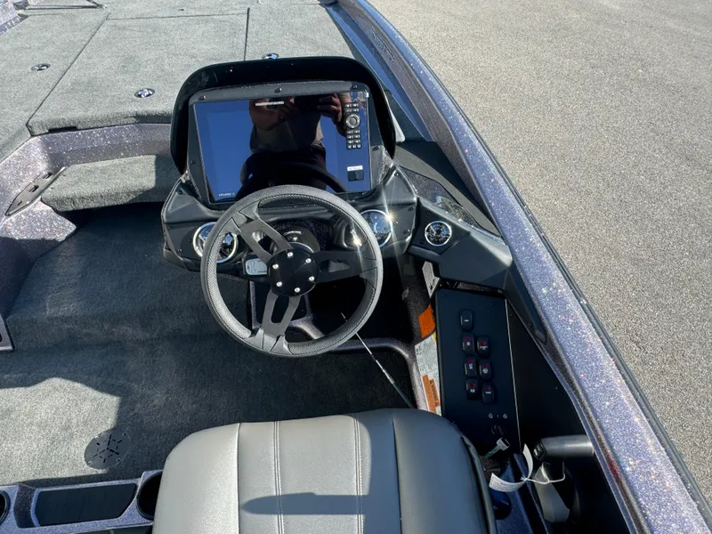 Slide: The Image of 2025 Skeeter ZXR20SE boat cockpit with steering wheel and digital display. - 13