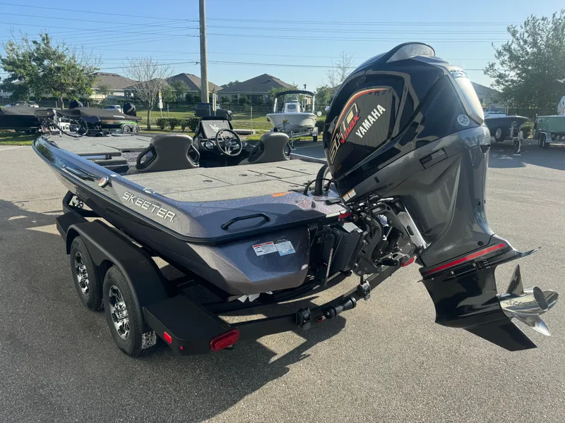 Slide: The Image of 2025 Skeeter ZXR20SE boat with Yamaha outboard motor, parked on a trailer. - 18