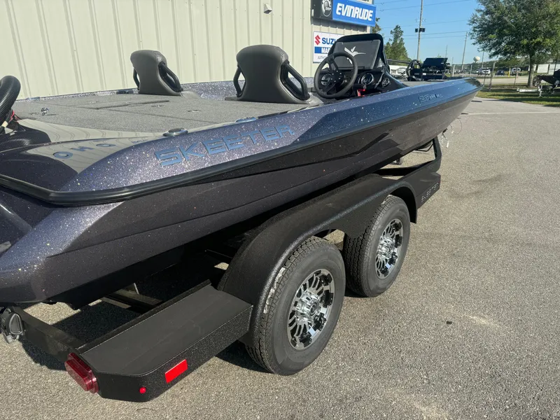 Slide: The Image of 2025 Skeeter ZXR20SE boat on trailer, parked outdoors, showcasing sleek design and dual seats. - 4