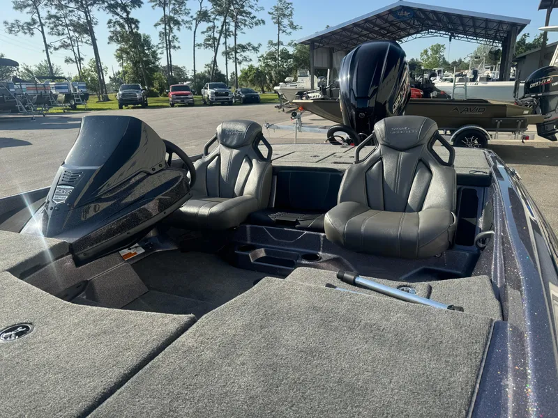 Slide: The Image of 2025 Skeeter ZXR20SE boat interior with dual seats and steering console. - 9