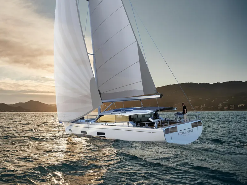 Slide: The Image of 2025 Moody 48 Deck Saloon sailing at sunset on open water. - 6