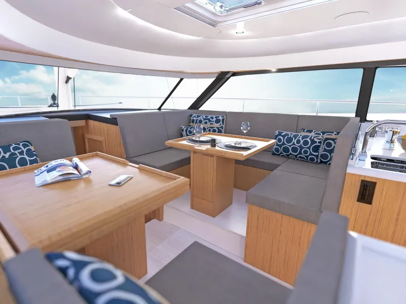 Slide: The Image of Luxurious interior of 2025 Moody 48 deck saloon yacht with modern seating and dining area. - 8