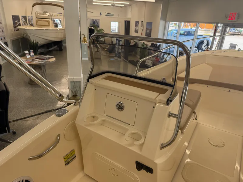 Slide: The Image of 2023 Scout 175 Sport Dorado boat interior with console and seating in showroom. - 6