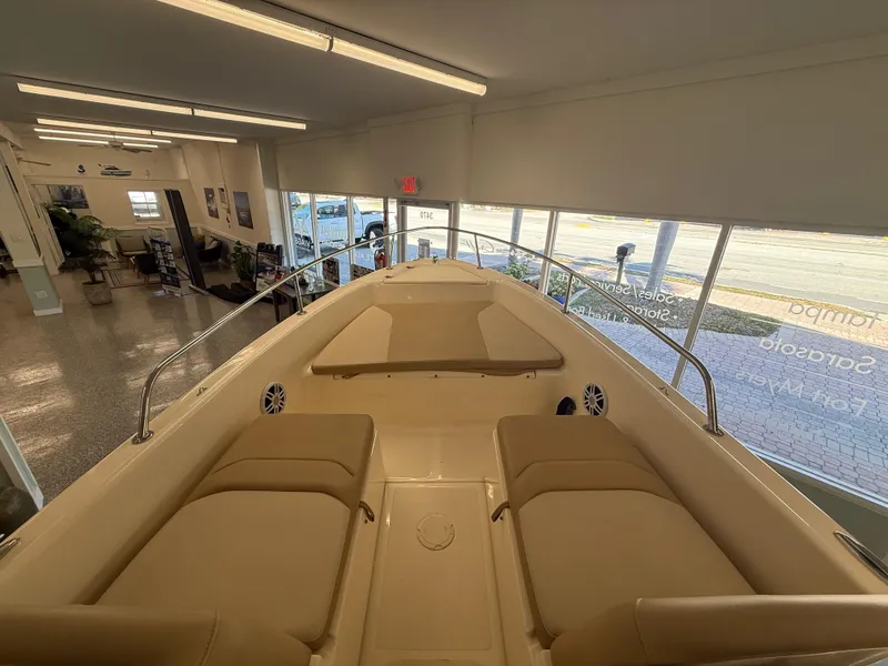Slide: The Image of 2023 Scout 175 Sport Dorado boat interior with beige seating in showroom. - 8