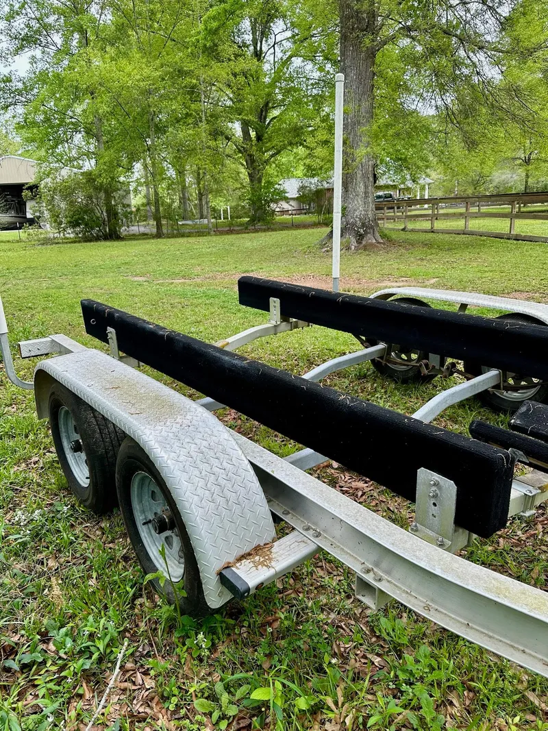 Slide: The Image of Trailer for 2007 Pro-Line 23 Express boat in grassy yard setting. - 24